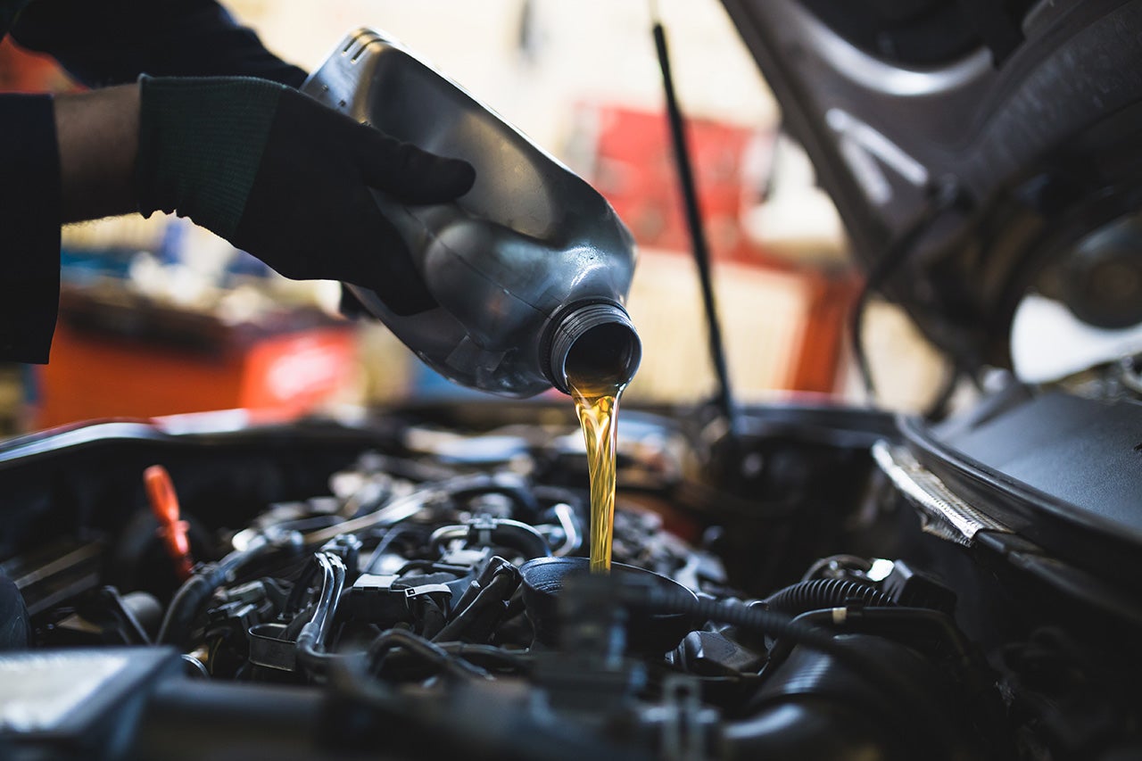 Technician performing an INFINITI oil change